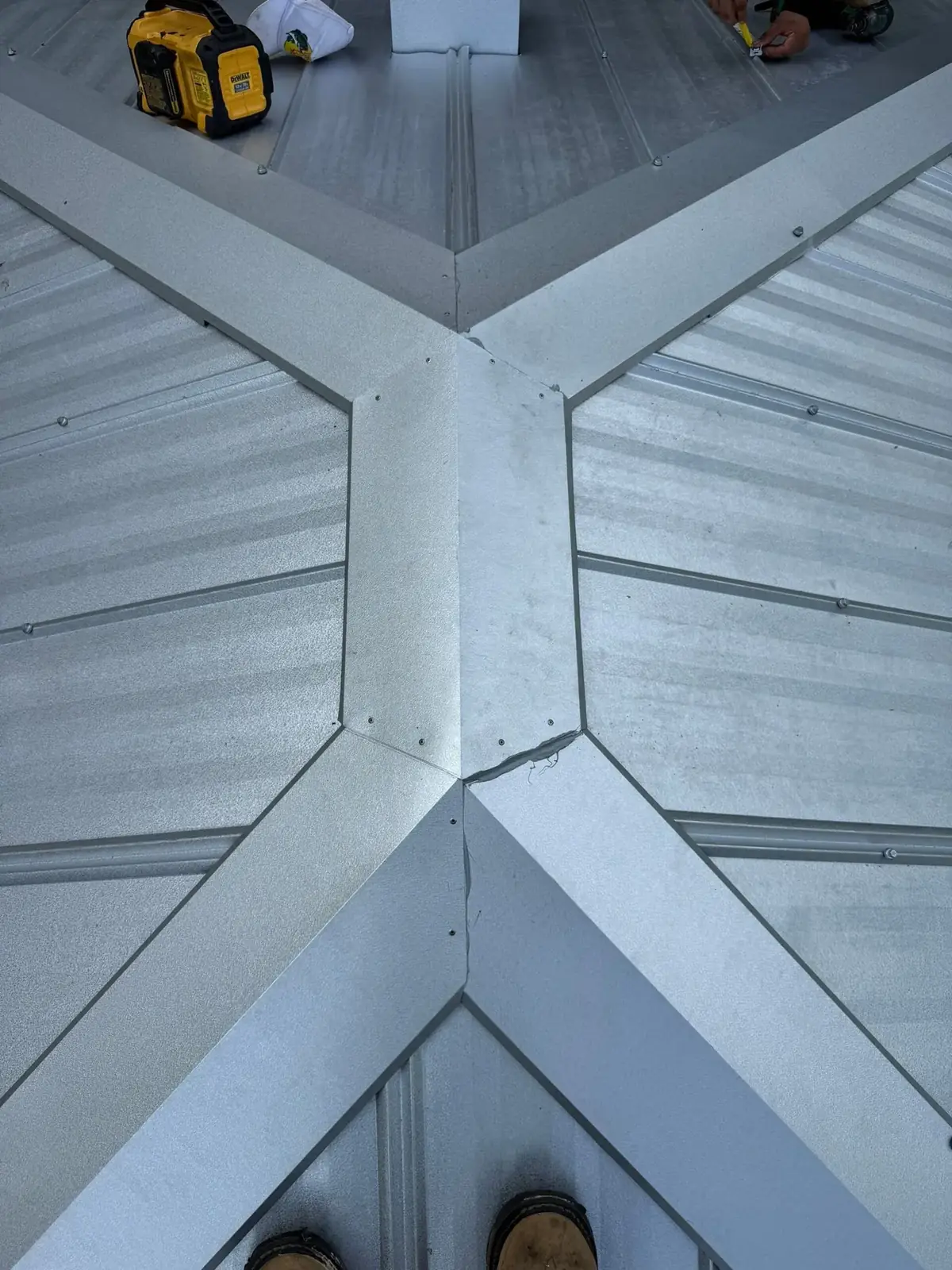 Custom 6 inch ridge caps on a mill finish 5V metal roof in Micanopy