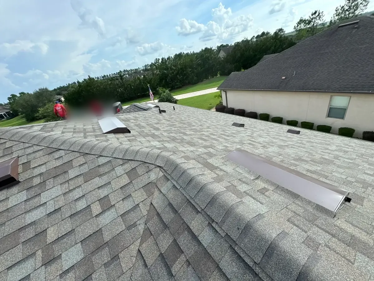 Crew installing Driftwood architectural shingles during an Ocala, FL roof replacement