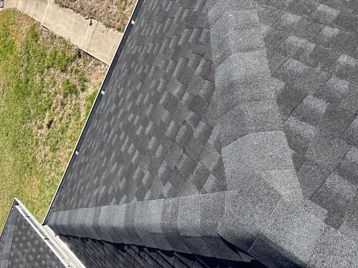 Looking straight down where two capped hips meet, above a walkway and lawn in Alachua