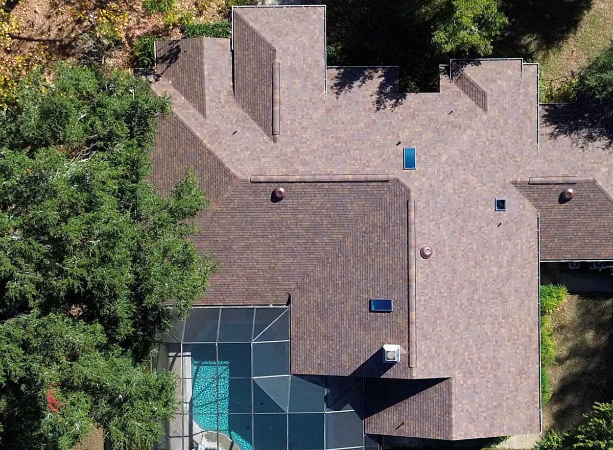 Straight-down drone view of the Alachua house showing its hips, gable ends and three skylights