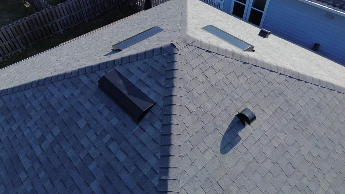 Close drone view of capped hips, box vents and a round exhaust hood in Alachua