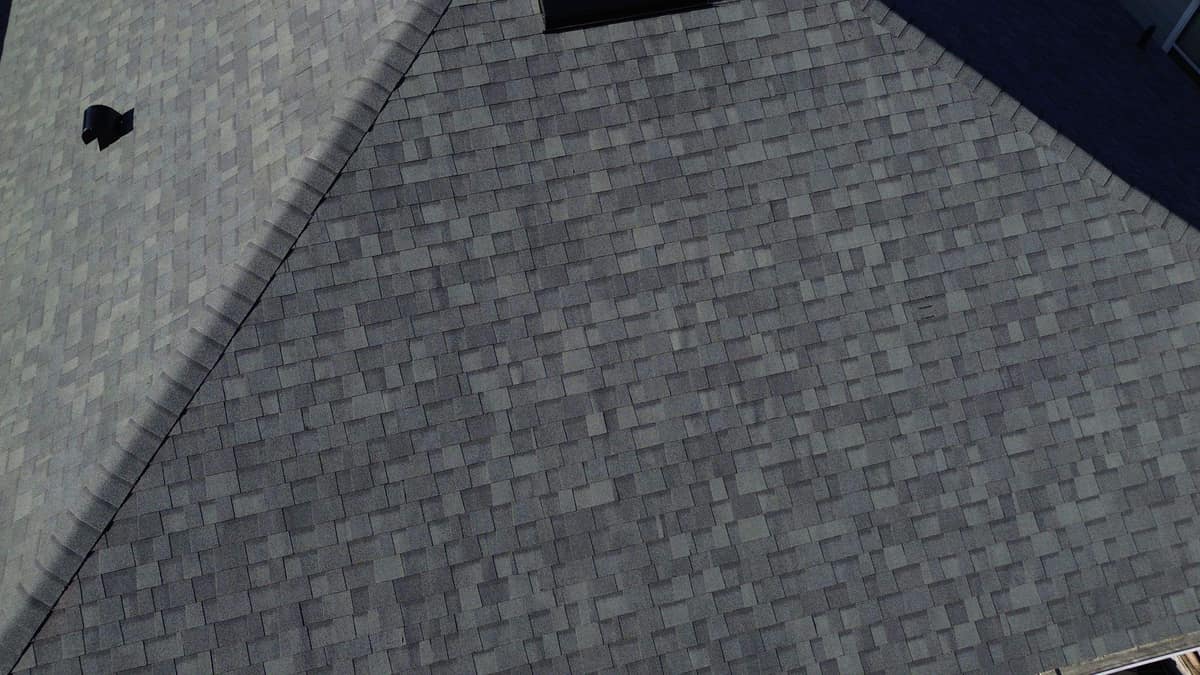 Close view of the gray blend shingles and a capped hip on the Alachua roof