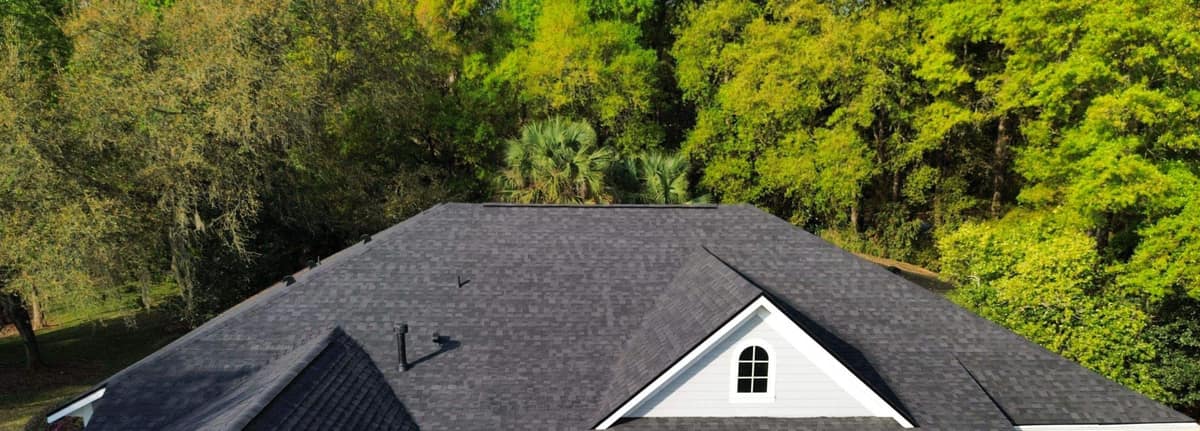 Front of the Gainesville home from above, with a hip roof, front gable and small arched window