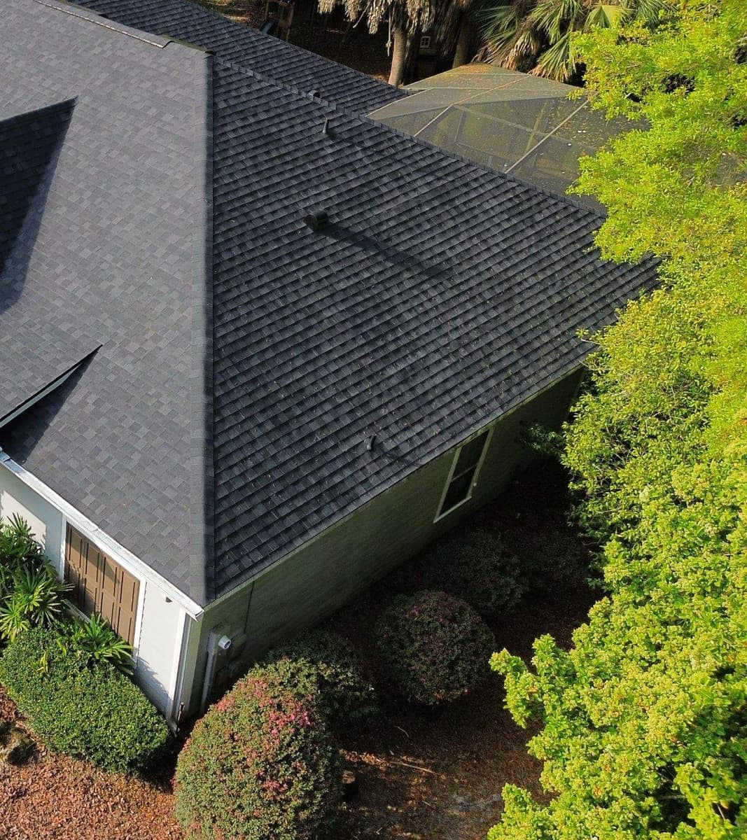 Overhead view of the far end of the Gainesville home, its side roof slope and screened enclosure