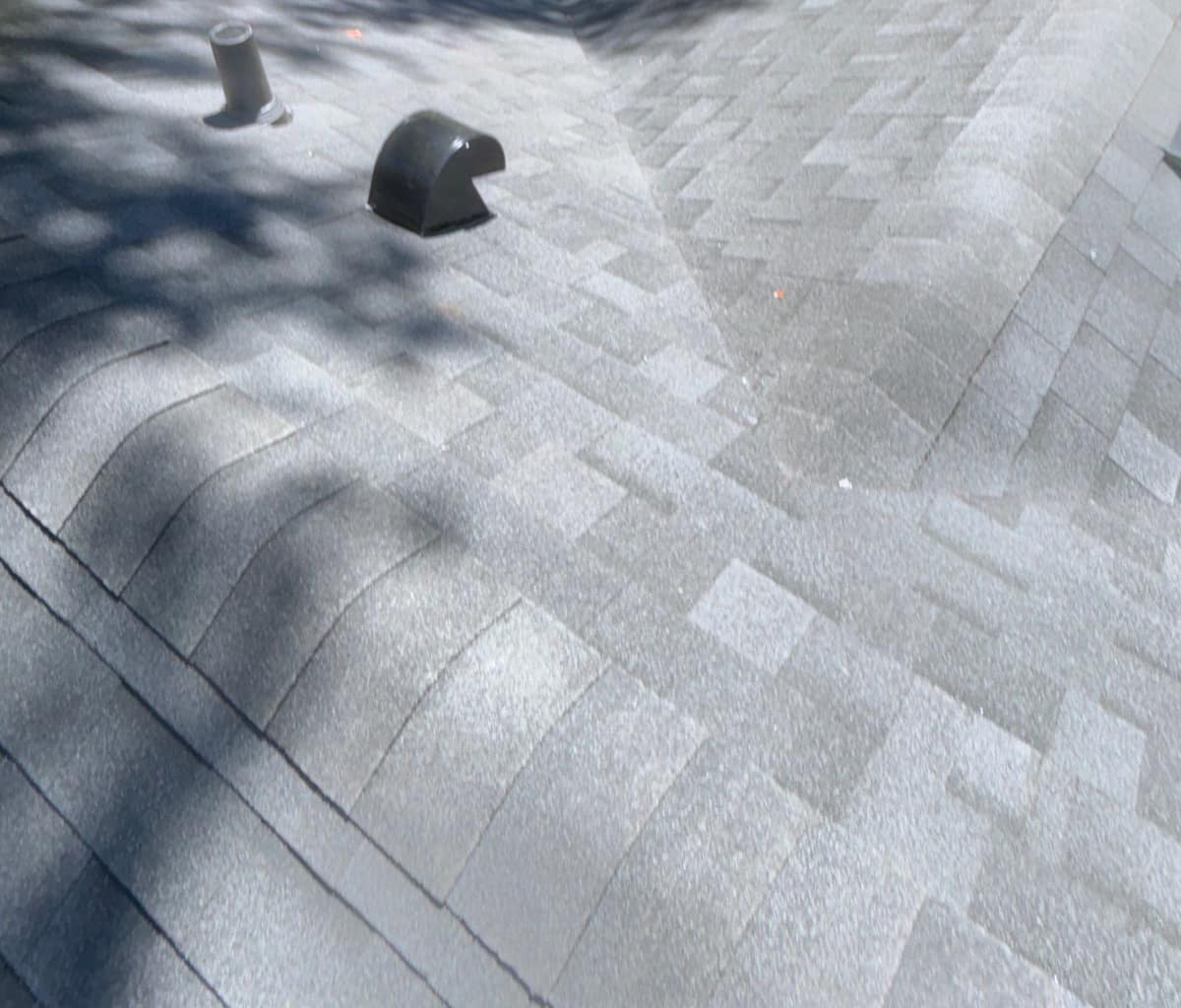 Plumbing vent pipe, a hooded exhaust vent and a shingled valley on the Gainesville roof