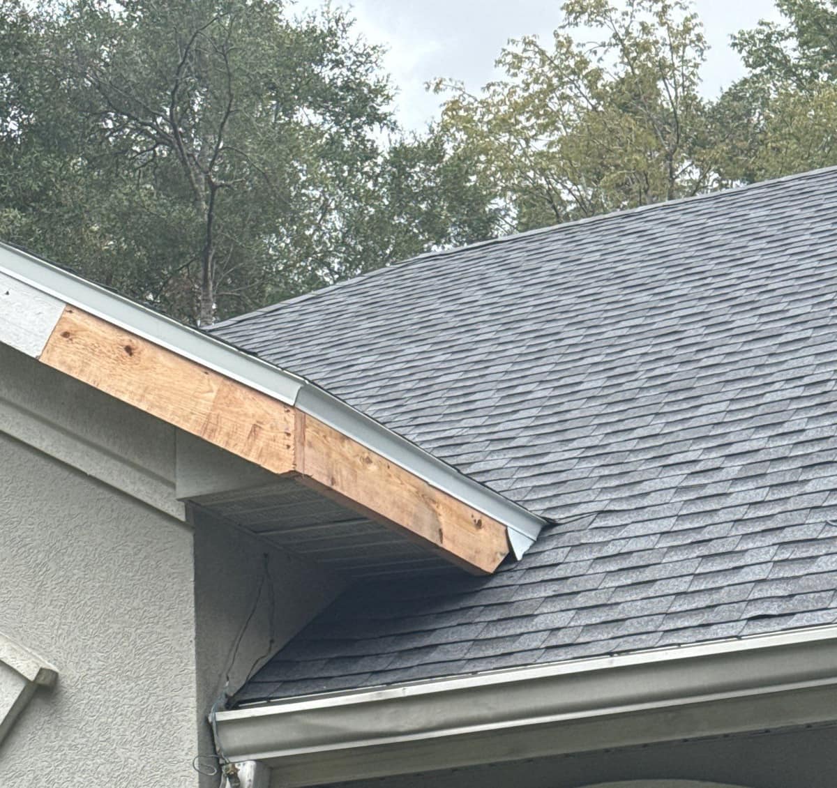 Close view of new unpainted fascia boards along a gable edge on the Gainesville house