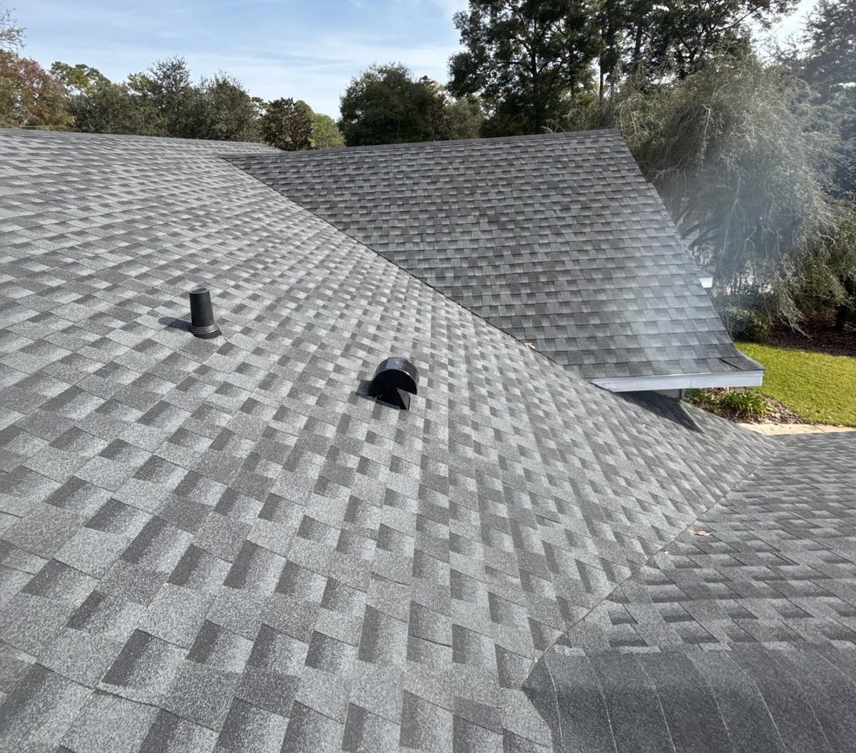 Medium gray architectural shingles on a Gainesville home, with a valley, a vent pipe and a lower wing