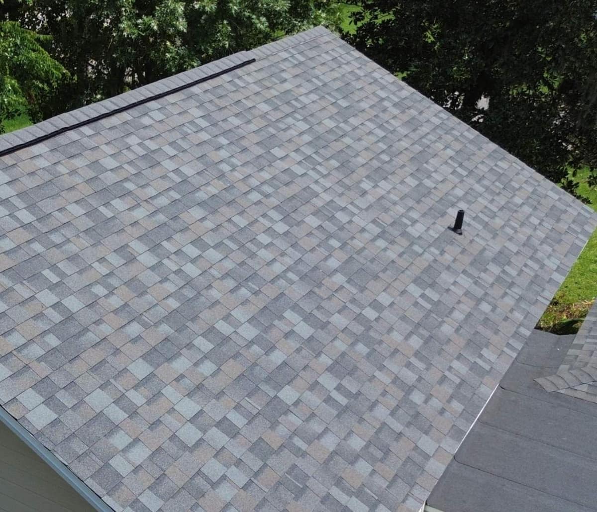 Overhead view of one slope of the Gainesville wing's gable roof with ridge vent and a vent pipe