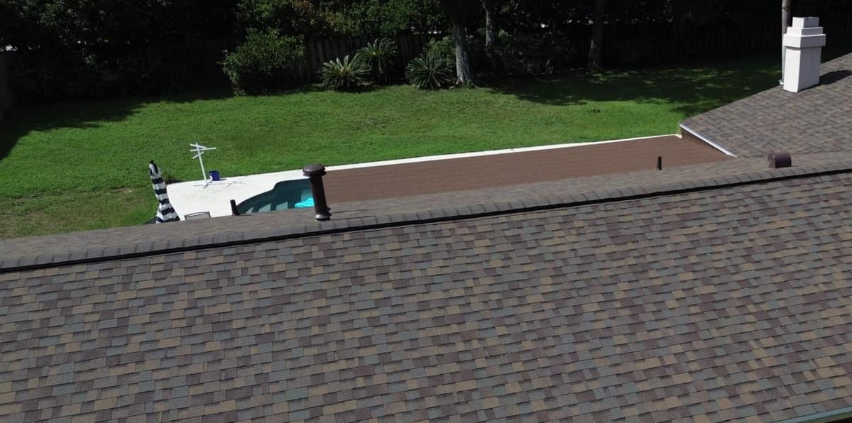 Drone view along the new brown shingle roof and ridge vent of a Gainesville home with a pool