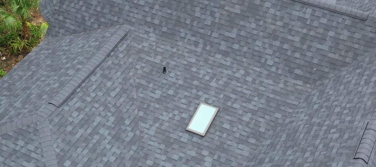 Looking down on the back slopes in Gainesville with a skylight, a vent pipe and capped ridge vents