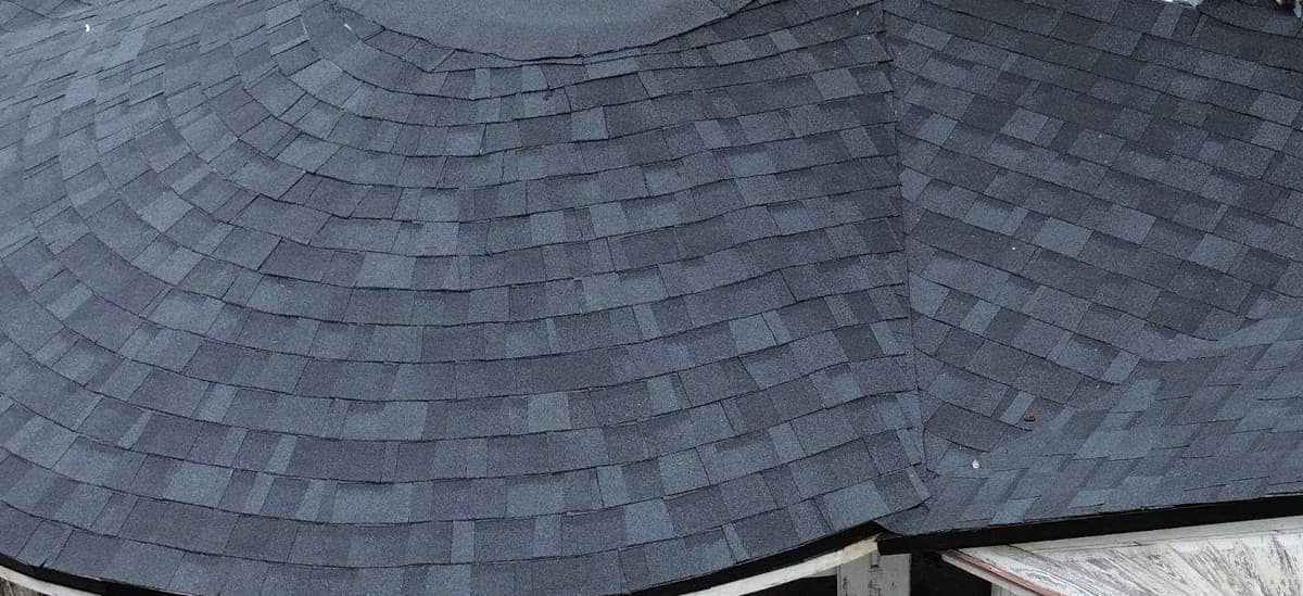 Shingles laid in arcs around the curved front porch roof of the Gainesville home