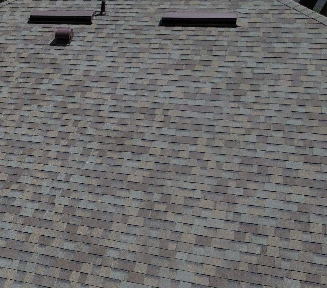 Two long low-profile vents, a hooded vent and a pipe vent on the back slope in Gainesville