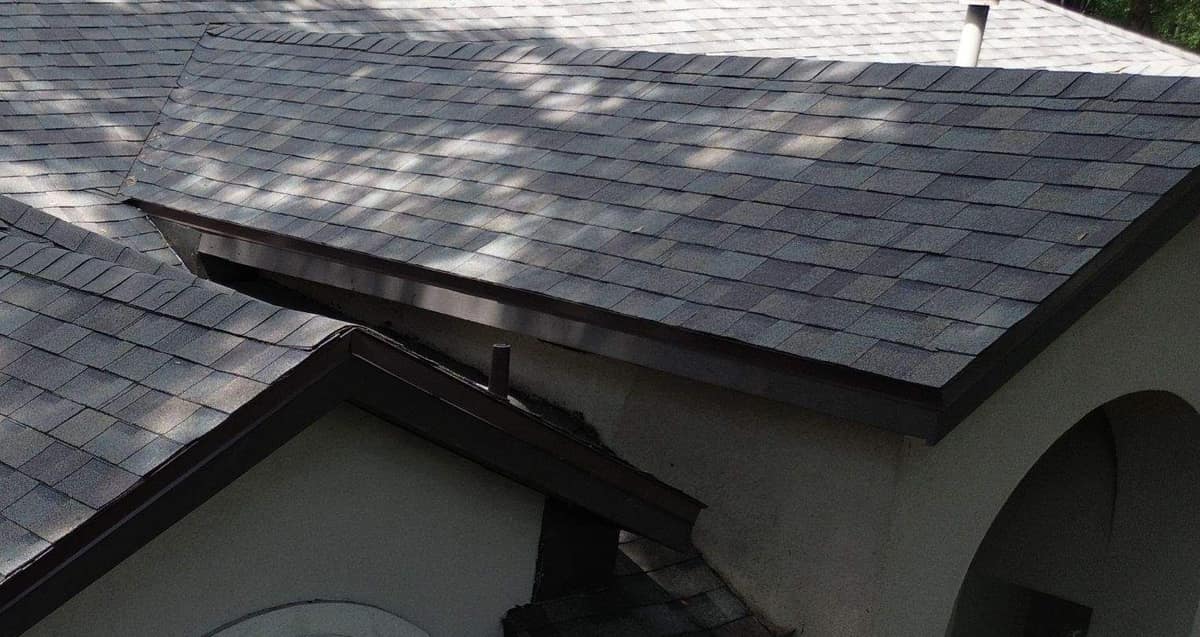 Brown drip edge along the entry porch roof where it meets the stucco wall in Gainesville