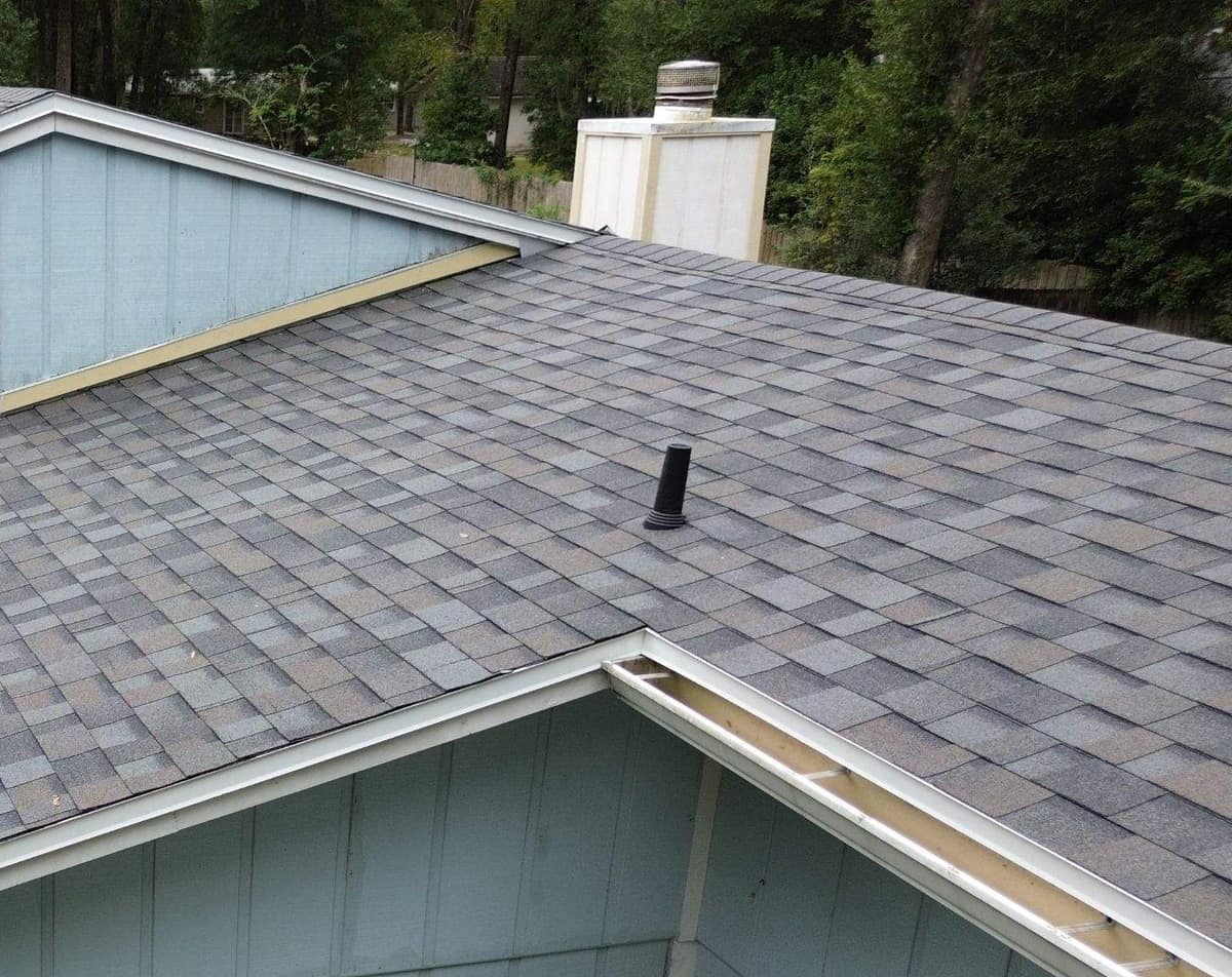 Light blue clerestory wall, cream chimney chase and a plumbing vent on the Gainesville roof
