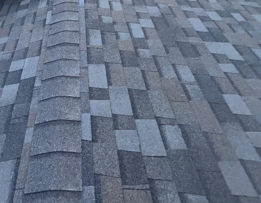 Close view of ridge cap shingles lapped along a ridge of the Gainesville home