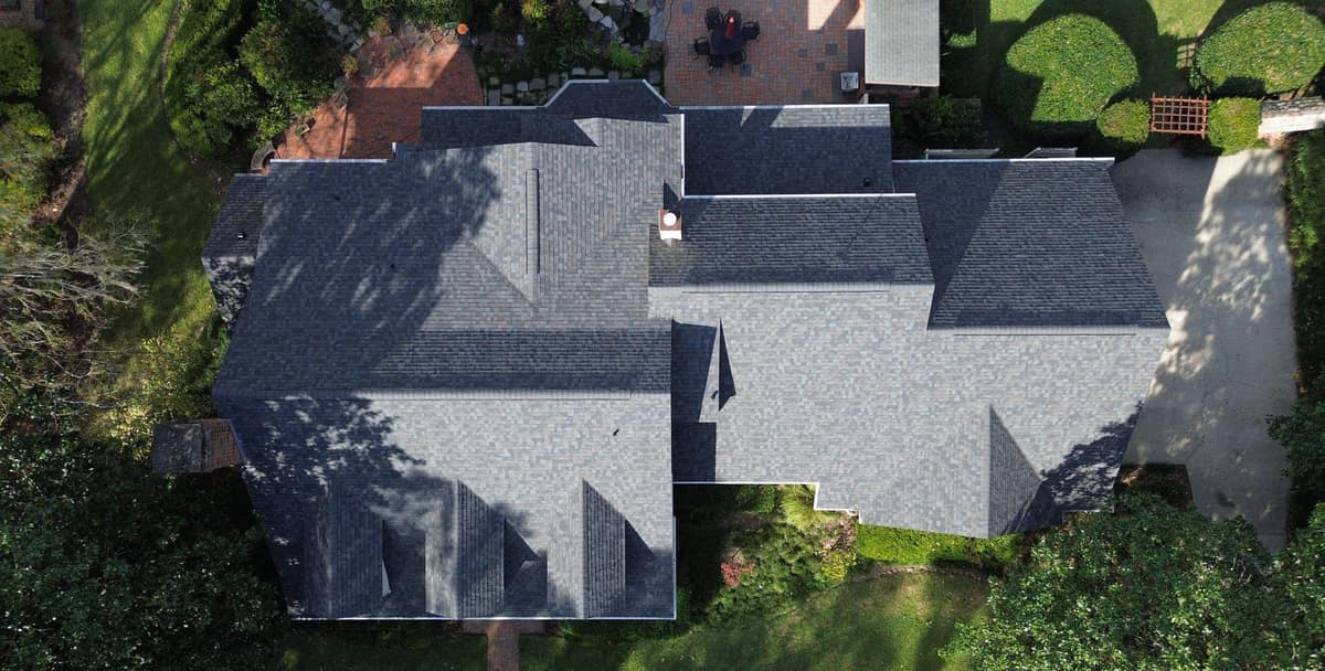Straight-down drone view of the new dark gray roof over a Gainesville home and its wing