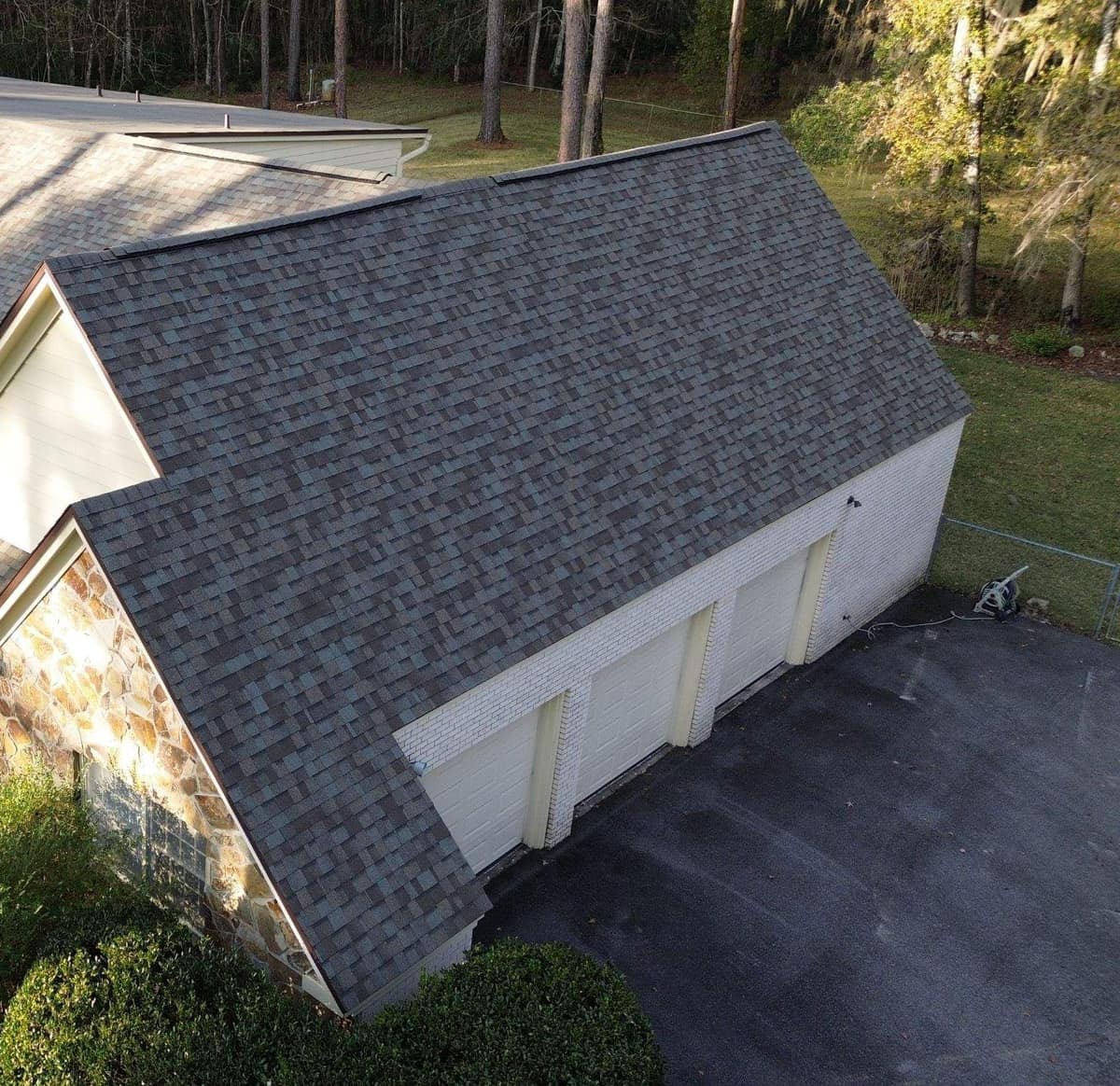 Drone view of the new shingle roof over the three-car garage wing of a Gainesville home