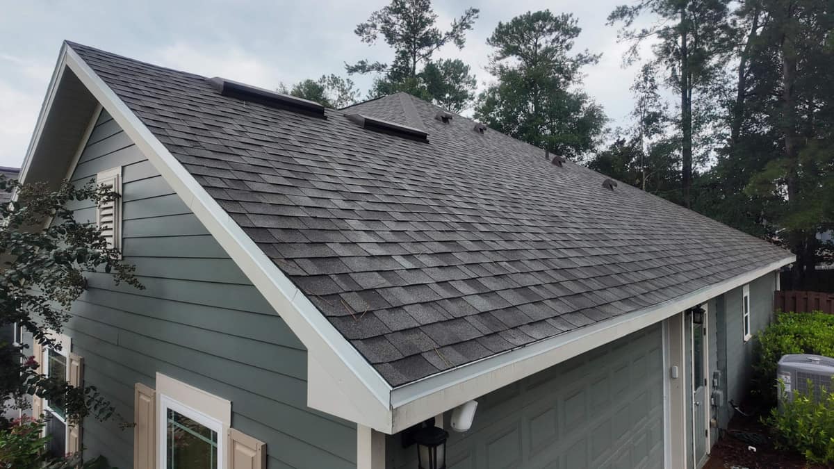 Drone view of the new gray shingle roof and white-trimmed gable on a Gainesville home