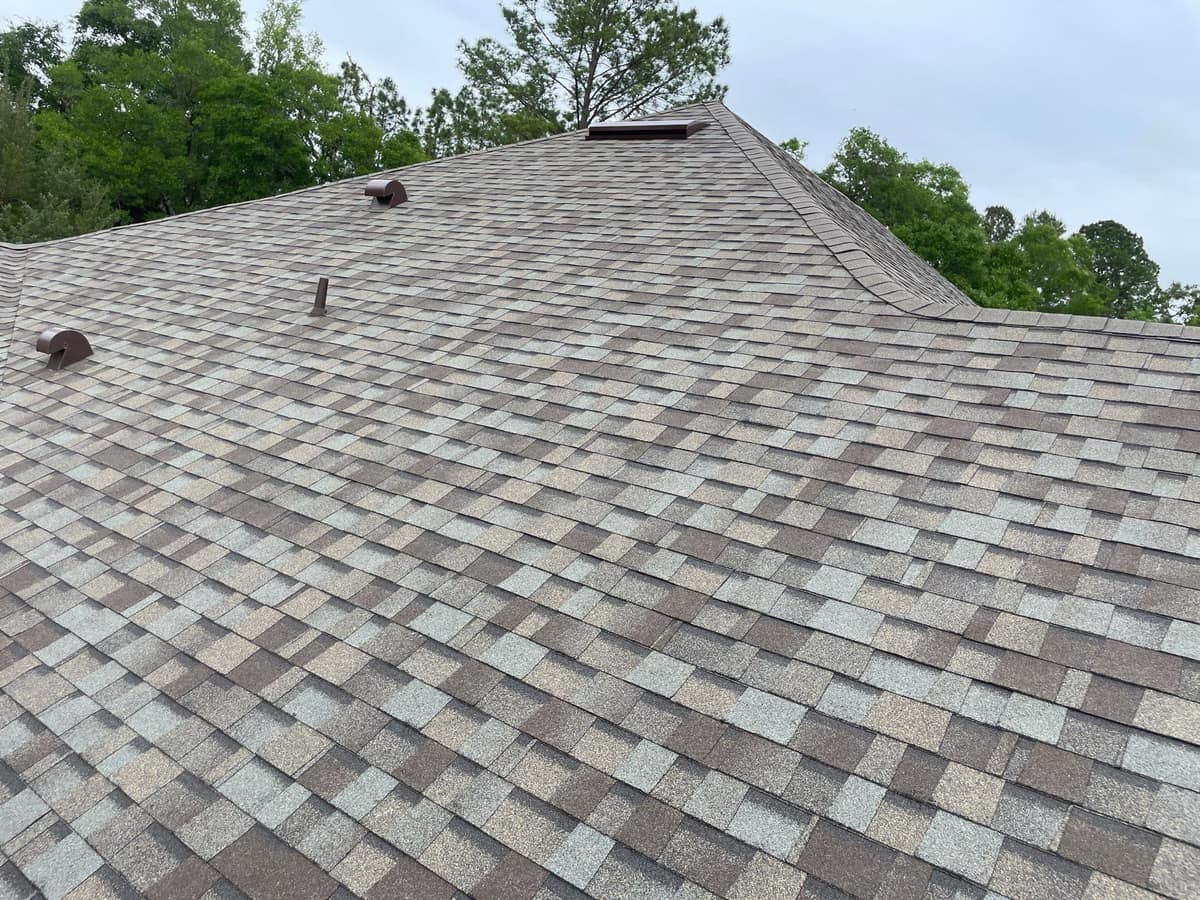 New gray, tan and brown architectural shingles on a hip roof in High Springs, with brown vents