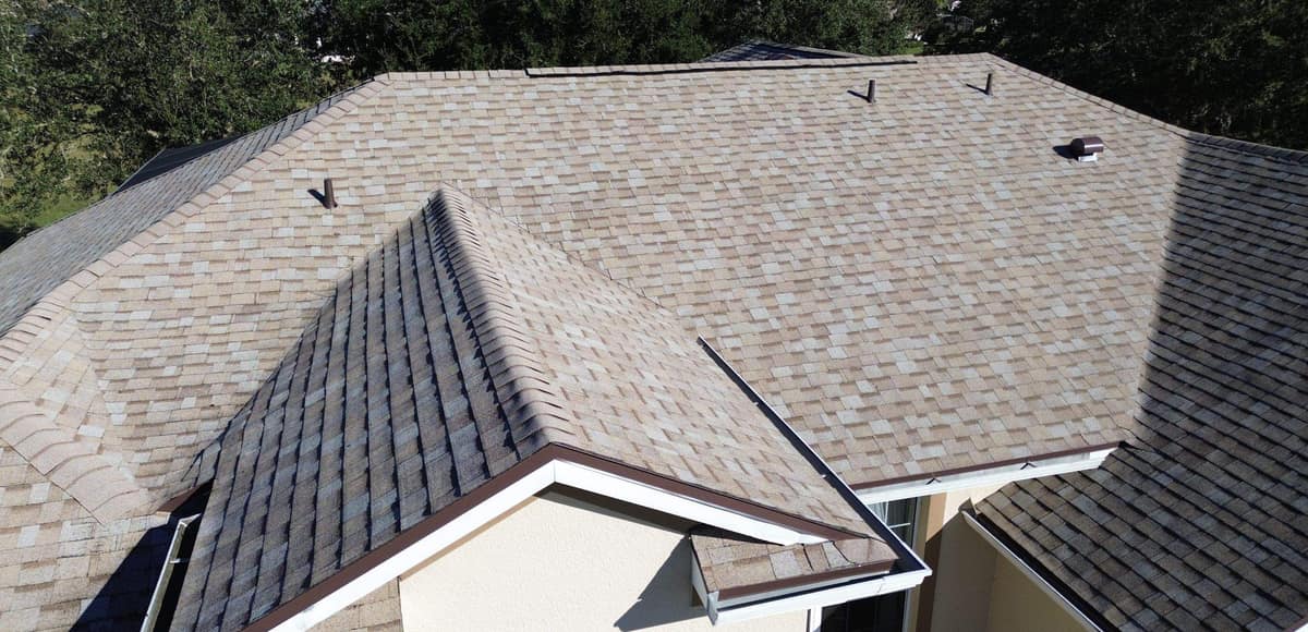 Front entry gable with brown drip edge set against the main roof field in Leesburg