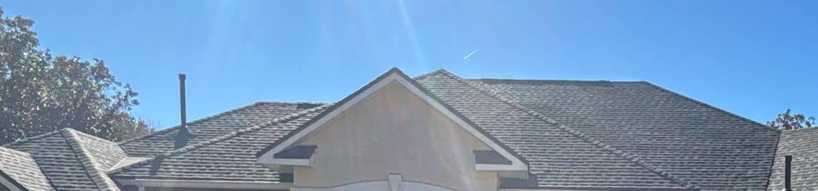 Stucco entry gable on the front of the Newberry home with new shingles on either side