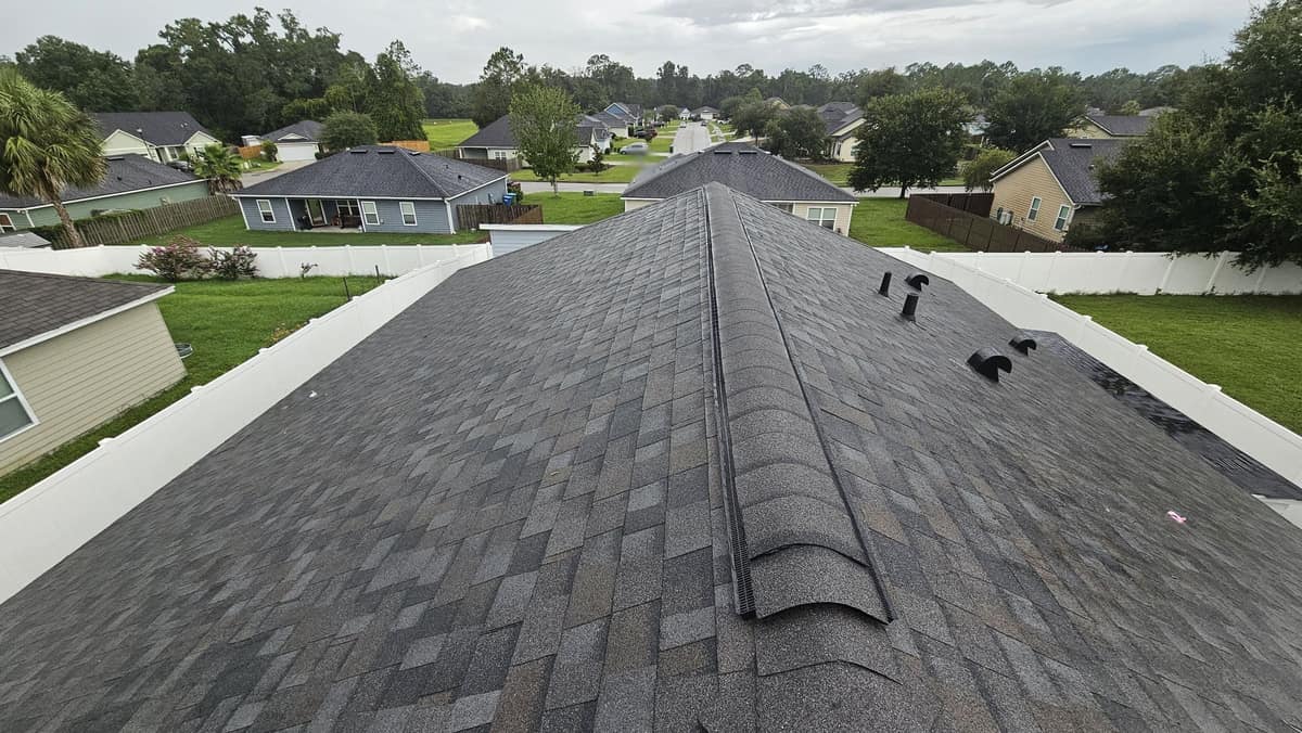 View down the main ridge of a Newberry home with a new ridge vent and charcoal shingles
