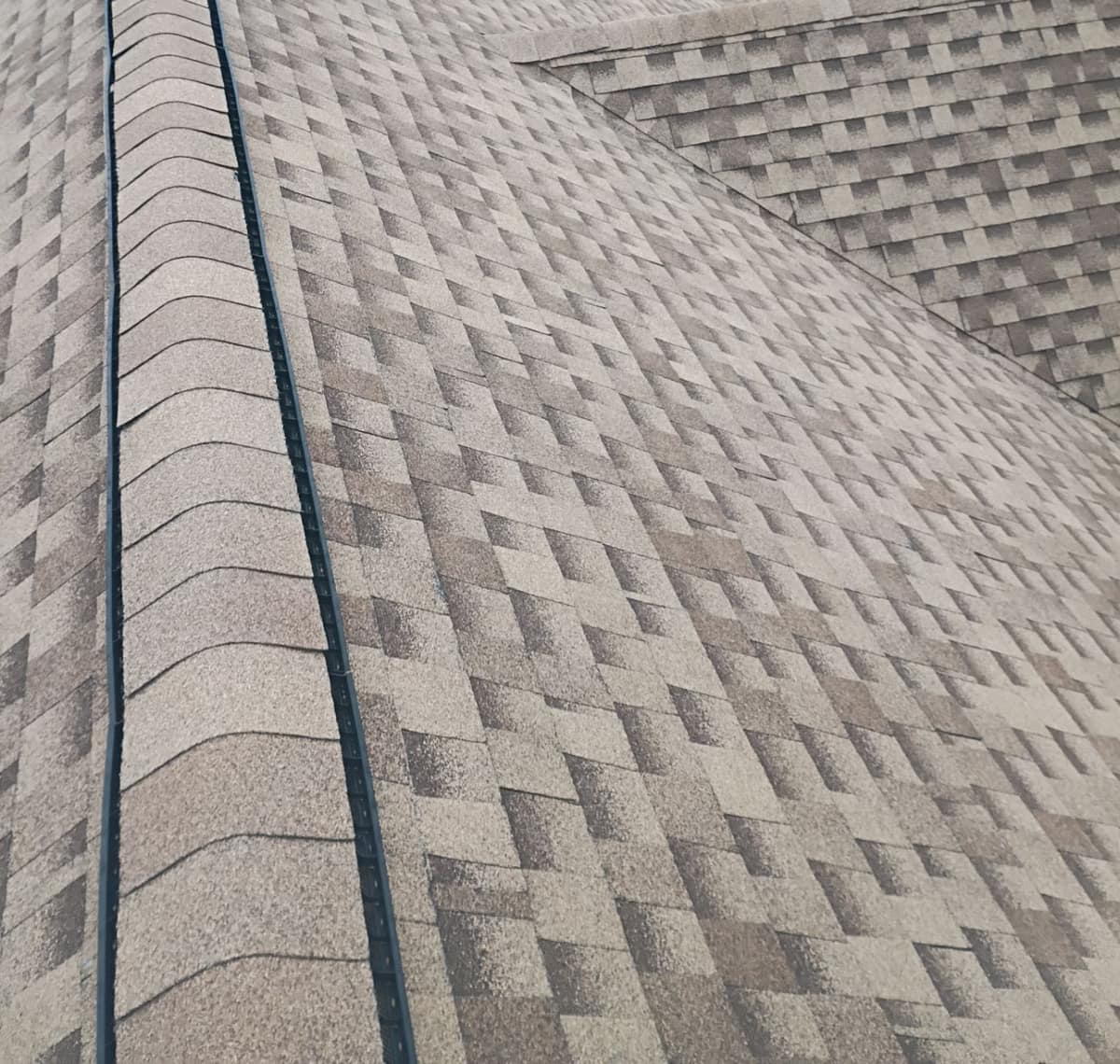 Close view of ridge cap shingles laid over the ridge vent on the Ocala roof