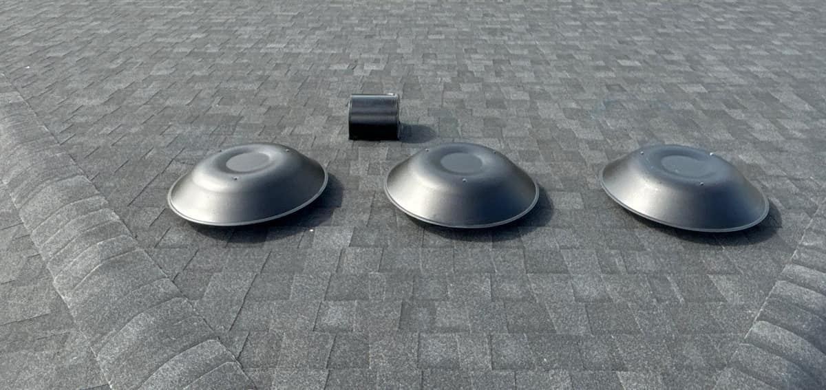 Three round dome vents and a small black exhaust hood on one roof slope in The Villages