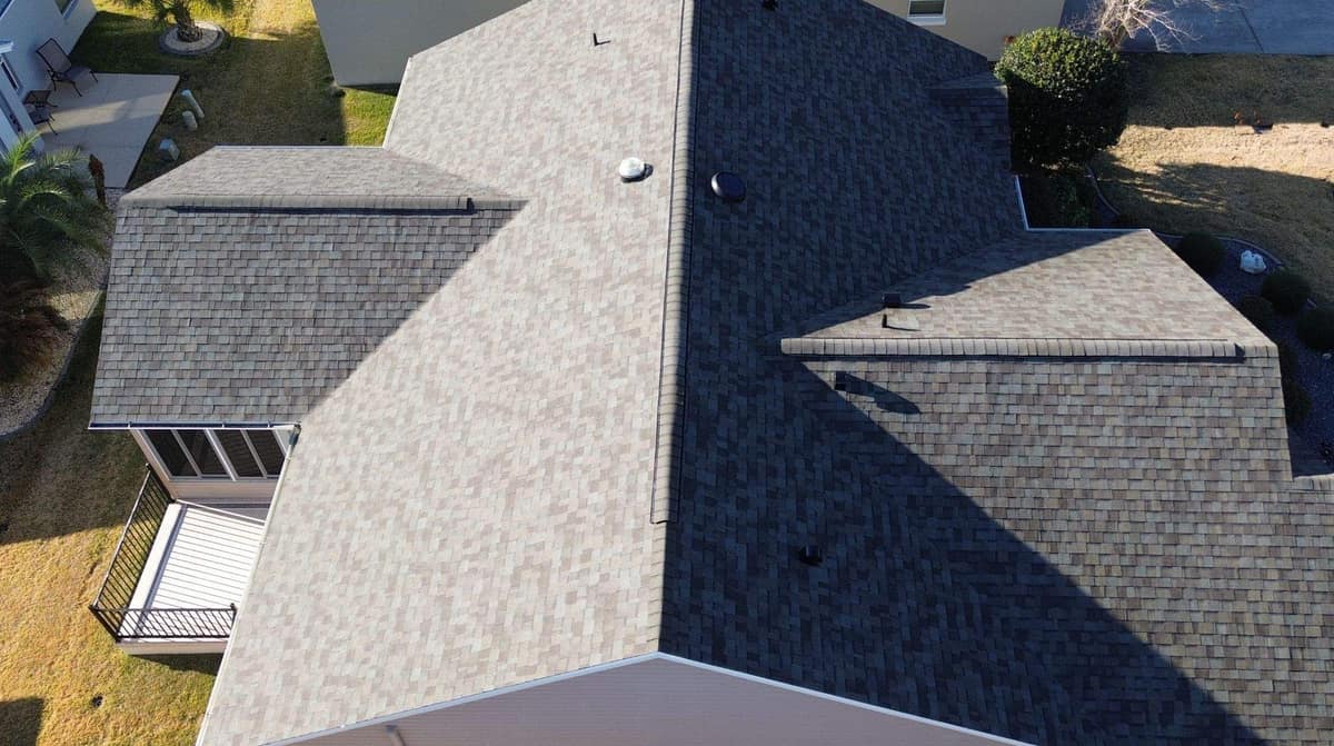 Drone view looking down across a gabled home in The Villages with a new shingle roof